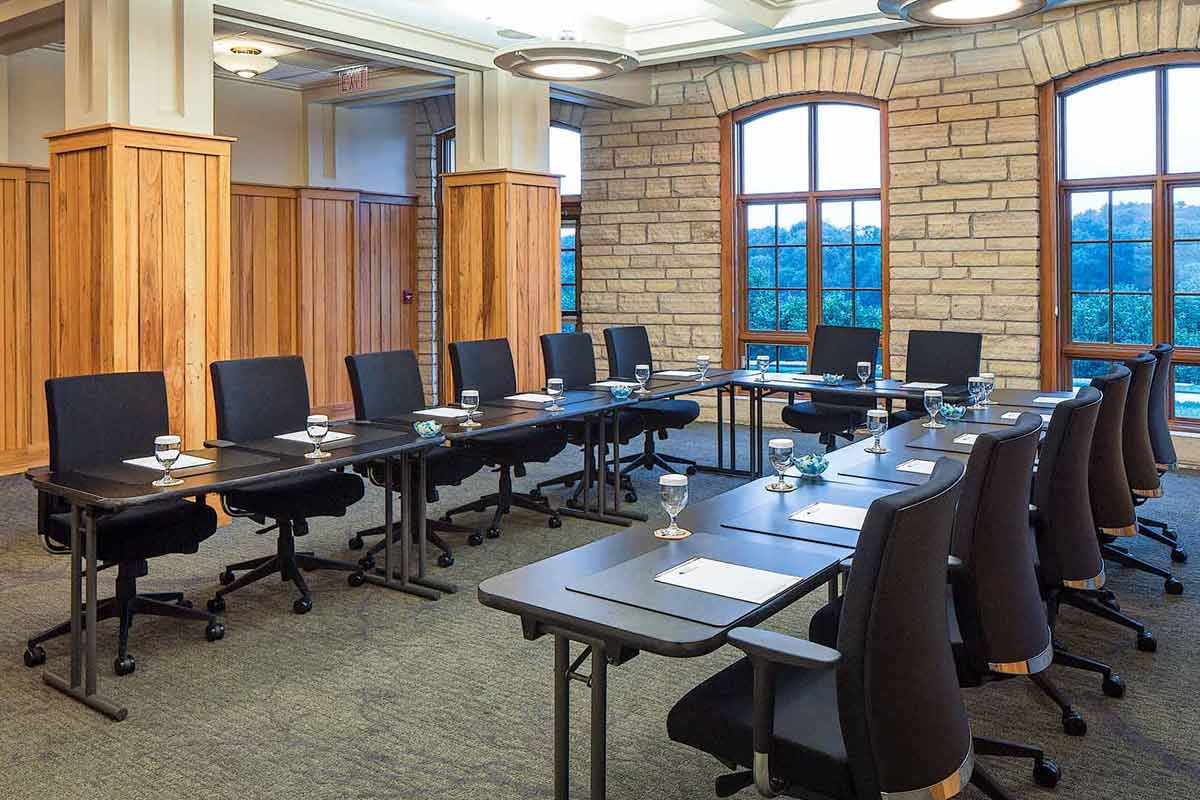 a conference room with comfy seating, ample desk space and gorgeous window views