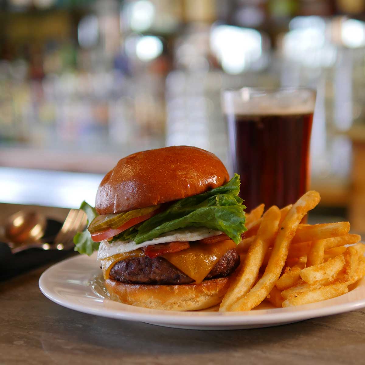 Timbers burger with fries and dark beer